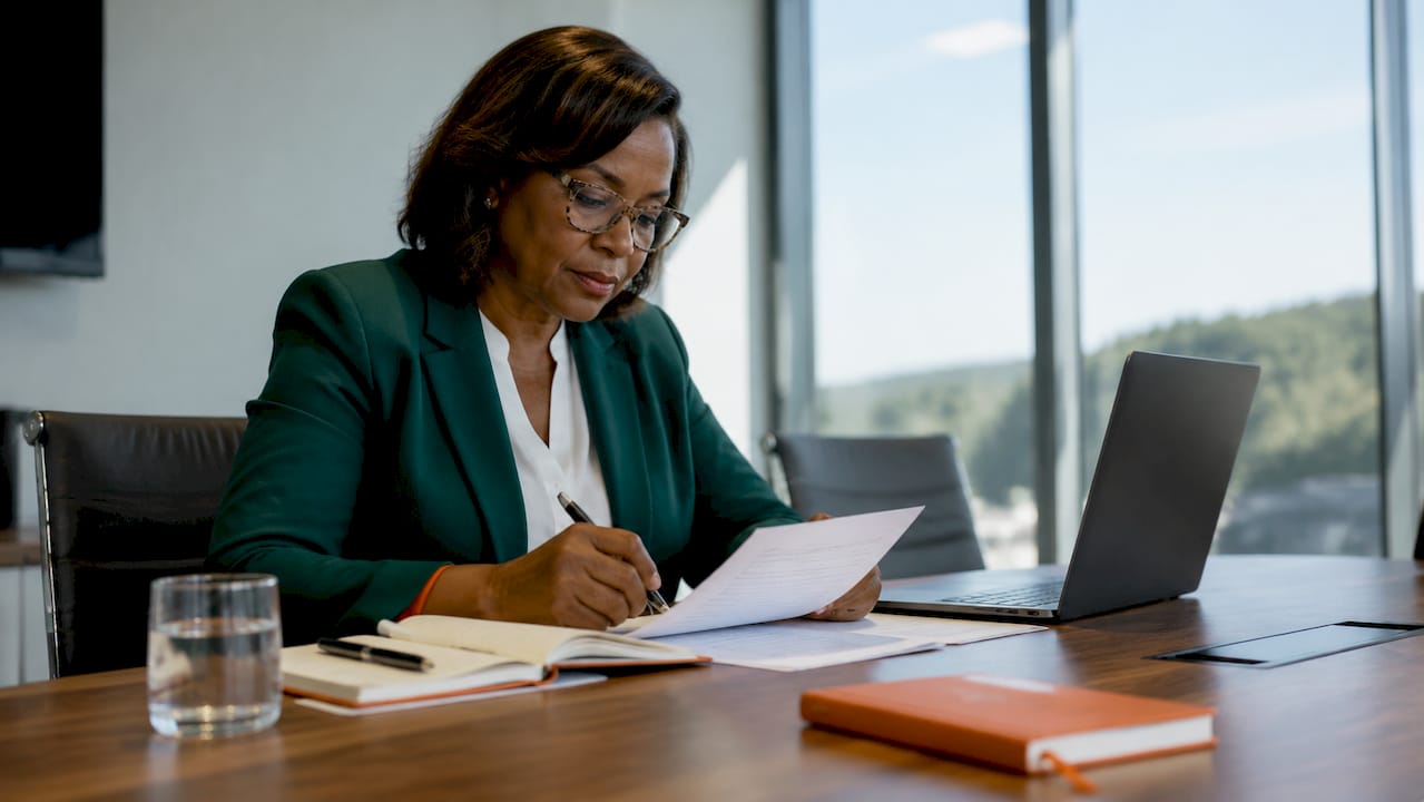Executive reading leadership materials in office