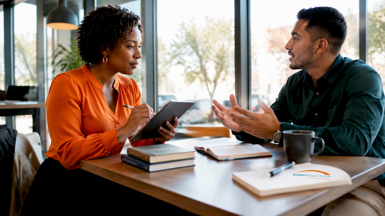 Career coach interacting with client in workspace